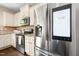 Modern kitchen with stainless steel appliances, including a refrigerator with a built-in smart screen at 317 Chamberlain Dr, Clayton, NC 27527