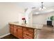 Kitchen island featuring dark wood cabinets and granite countertop in an open concept kitchen and living space at 317 Chamberlain Dr, Clayton, NC 27527