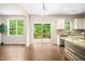 Open kitchen with granite countertops, view to the deck, and stainless steel appliances at 317 Chamberlain Dr, Clayton, NC 27527