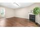 Comfortable living room with a fireplace, large window, and hardwood floors at 317 Chamberlain Dr, Clayton, NC 27527
