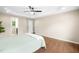 Bright main bedroom with a ceiling fan, tray ceiling, wood floor and ensuite bathroom at 317 Chamberlain Dr, Clayton, NC 27527