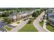 Scenic street view showcases a row of well-maintained townhomes with lush green landscaping and mature trees at 317 Chamberlain Dr, Clayton, NC 27527
