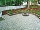 Paver patio in backyard with retaining wall and fire pit at 3300 Neuse Crossing Dr, Raleigh, NC 27616
