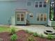Back of house with paver patio, mulch landscaping, and firepit at 3300 Neuse Crossing Dr, Raleigh, NC 27616