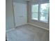 Bright bedroom with plush carpet, a window, and a closet with double doors at 3300 Neuse Crossing Dr, Raleigh, NC 27616