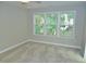 Neutral bedroom with three sunny windows, plush carpeting, and a ceiling fan at 3300 Neuse Crossing Dr, Raleigh, NC 27616