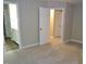 Spacious carpeted primary bedroom with open door to bathroom with dual vanity at 3300 Neuse Crossing Dr, Raleigh, NC 27616