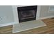 Close-up of a fireplace featuring a decorative mantle and hearth on hardwood floors at 3300 Neuse Crossing Dr, Raleigh, NC 27616