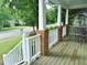 Covered front porch features classic brick pillars, white railings, and an open view of the neighborhood at 3300 Neuse Crossing Dr, Raleigh, NC 27616