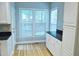 Bright kitchen with white cabinets, dark countertops, and stainless steel appliances with eat in space at 3300 Neuse Crossing Dr, Raleigh, NC 27616