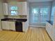 Bright kitchen with white cabinets, dark countertops, and stainless steel appliances with eat in space at 3300 Neuse Crossing Dr, Raleigh, NC 27616