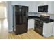 Modern kitchen features stainless steel appliances, sleek black countertops, and white cabinetry at 3300 Neuse Crossing Dr, Raleigh, NC 27616