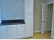 Bright kitchen with white cabinets, dark countertops and a walk-in pantry for ample storage at 3300 Neuse Crossing Dr, Raleigh, NC 27616