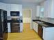 Modern kitchen features stainless steel appliances, sleek black countertops, and white cabinetry at 3300 Neuse Crossing Dr, Raleigh, NC 27616