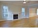 Cozy living room with a fireplace, hardwood floors, neutral paint and natural light from large windows at 3300 Neuse Crossing Dr, Raleigh, NC 27616