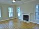 Spacious living room with hardwood floors and a fireplace, filled with natural light at 3300 Neuse Crossing Dr, Raleigh, NC 27616