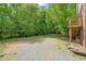 The home's backyard features ample parking and an elevated wooden deck at 34 Johnston St, Pittsboro, NC 27312