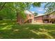 Spacious backyard featuring a charming brick home with a wooden deck and stairs at 34 Johnston St, Pittsboro, NC 27312