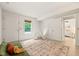 Spacious basement area with tan tile flooring, a sofa, tent, and multiple doorways at 34 Johnston St, Pittsboro, NC 27312