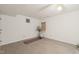 Clean basement with neutral paint, tile flooring, and space for exercise equipment at 34 Johnston St, Pittsboro, NC 27312