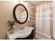 Traditional bathroom featuring vanity, framed mirror, and shower with decorative tile at 34 Johnston St, Pittsboro, NC 27312