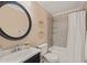 Well-lit bathroom featuring a vanity, toilet, and shower with tiled surround at 34 Johnston St, Pittsboro, NC 27312