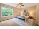 Bright bedroom with a large window, ceiling fan, and modern furniture at 34 Johnston St, Pittsboro, NC 27312