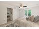 Bedroom with neutral paint and a window showcasing a treed outdoor view at 34 Johnston St, Pittsboro, NC 27312