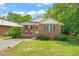Charming brick home with a cozy front porch and a well-manicured lawn at 34 Johnston St, Pittsboro, NC 27312