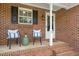 Close up of a inviting front porch with comfortable seating and decorative touches at 34 Johnston St, Pittsboro, NC 27312