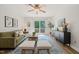 Bright living room with plush seating, stylish rug, and sliding glass doors to a deck at 34 Johnston St, Pittsboro, NC 27312