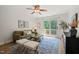 Cozy living room with comfortable couch, patterned rug, and access to outdoor deck at 34 Johnston St, Pittsboro, NC 27312