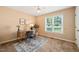 Home office with natural light, wooden desk, and neutral carpet at 34 Johnston St, Pittsboro, NC 27312