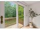 Patio door with bronze hardware leading to a wooden deck overlooking a lush backyard at 34 Johnston St, Pittsboro, NC 27312