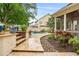 Landscaped backyard featuring a stone patio, in-ground pool and screened-in porch at 3821 Falls River Ave, Raleigh, NC 27614