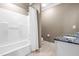 Bathroom with shower-tub combo and granite vanity, all in neutral colors at 3821 Falls River Ave, Raleigh, NC 27614