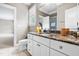 Bathroom featuring granite countertops, white cabinets, tiled floors and adjoined bedroom with light tan walls at 3821 Falls River Ave, Raleigh, NC 27614