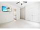 Bright bedroom featuring a television, light tan walls, white trim, an ensuite bathroom, and plush carpeting at 3821 Falls River Ave, Raleigh, NC 27614