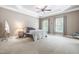 Bright bedroom featuring two large windows, neutral walls, and plush carpet, creating a cozy and inviting atmosphere at 3821 Falls River Ave, Raleigh, NC 27614