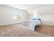 A bedroom that is well-lit with many windows, a bed, and carpet at 3821 Falls River Ave, Raleigh, NC 27614