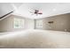 Expansive bonus room featuring great natural light, a ceiling fan, and modern finishes at 3821 Falls River Ave, Raleigh, NC 27614