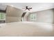 Spacious bonus room with windows and ample natural light and a ceiling fan at 3821 Falls River Ave, Raleigh, NC 27614