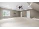 Large bonus room area with lots of windows, a ceiling fan and easy access to the bathroom at 3821 Falls River Ave, Raleigh, NC 27614