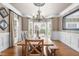 Elegant dining room featuring natural light from windows and classic chandelier lighting at 3821 Falls River Ave, Raleigh, NC 27614