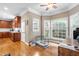 Bright dining area with hardwood floors, multiple windows, and a pet cage at 3821 Falls River Ave, Raleigh, NC 27614