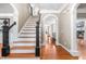 Stunning foyer featuring hardwood floors, staircase and beautiful archways at 3821 Falls River Ave, Raleigh, NC 27614