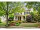 Inviting two-story home featuring a charming front porch and professionally landscaped yard at 3821 Falls River Ave, Raleigh, NC 27614