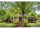 Charming two-story home featuring a welcoming front porch and meticulously maintained landscaping at 3821 Falls River Ave, Raleigh, NC 27614