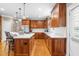 Gourmet kitchen features custom cabinets, marble counters, large island, and stainless appliances at 3821 Falls River Ave, Raleigh, NC 27614