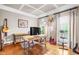 Office space with wood floors, desk, and natural light from large windows with decorative curtains at 3821 Falls River Ave, Raleigh, NC 27614